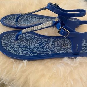 Blue Guess jelly type flat sandals.